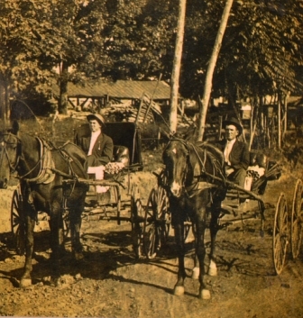 W.T. Simms and W.F. Youngblood in circa 1915 were rural mail carriers. Notice the round tubs are the Yorkville Enquirer newspaper being delivered.